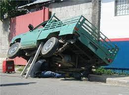 Man under truck on 2x4 board.jpg